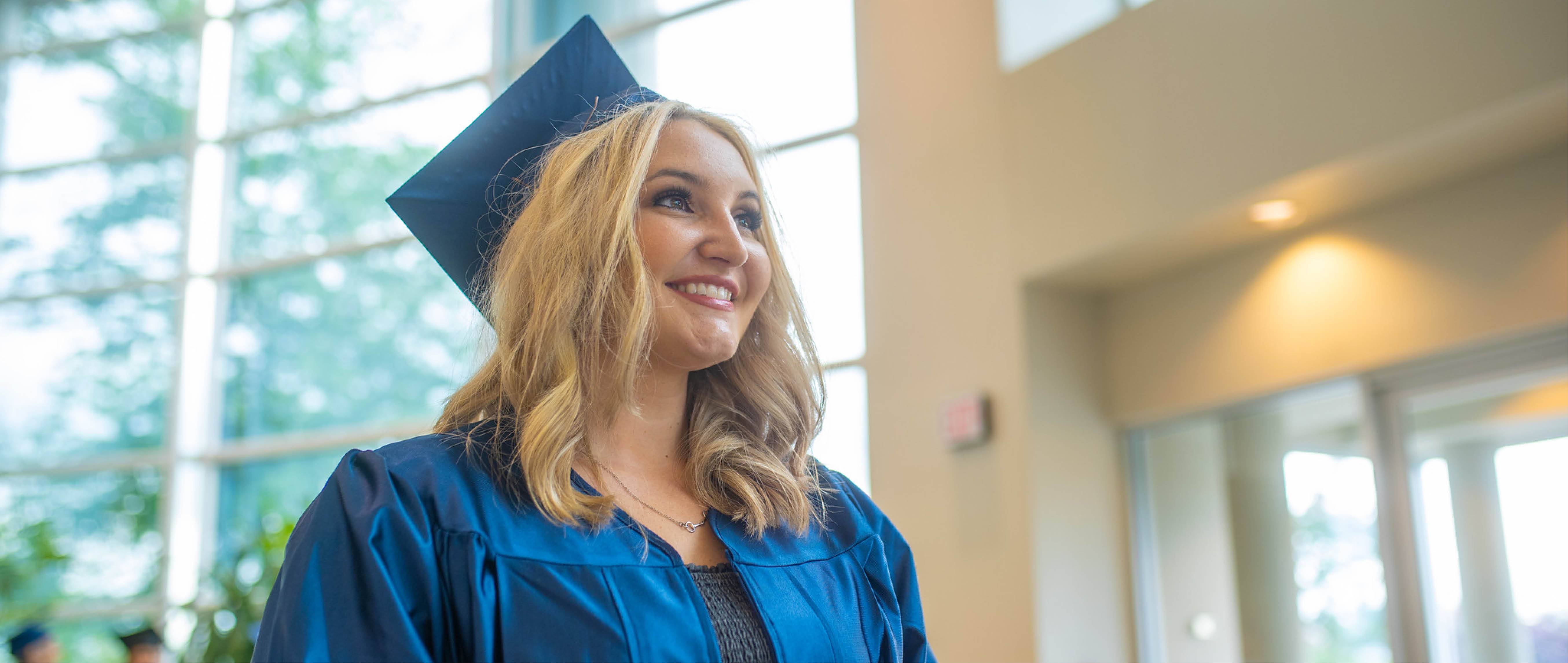 female student in cap and gown